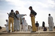 Displaced Pakistani tribal people, who fled the tribal area of Waziristan along the Afghanistan border after fighting between security forces and militants, are checked Friday by security personal prior to receiving relief supplies in Dera Ismail Khan, Pakistan. Militants are increasingly turning against the Pakistani government that once nurtured them, creating what the information minister for North West Frontier Province calls “a guerrilla war.”