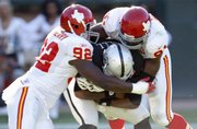 Kansas City’s Wallace Gilbery (92) and Tamba Hali sack Oakland QB Jamarcus Russell. The Chiefs beat the Raiders, 16-10, Sunday in Oakland, Calif.