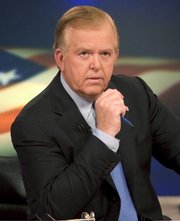 News anchor Lou Dobbs sits on the set of his show, “Lou Dobbs Tonight,” in New York in this 2005 file photo.