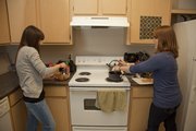KU students Nina Riley, left, and Nancy Griego live, cook and blog the many recipes they use together.