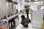 Sidney LaFontant, front, shops for a dishwasher with her husband, Les, and their son Jonathan, 1, in this Sept. 4 photo at P.C. Richard & Son appliance store in New York. A new stimulus program will offer cash for energy-efficient appliance purchases.