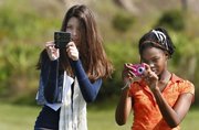 Wiregrass Ranch High School students Nicolette Doria, left, and Alexia Browne, use their cell phones to shoot photos during their science class Nov. 4 in Wesley Chapel, Fla.