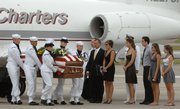 The family of Captain Michael “Scott” Speicher watches as his remains are moved from the jet to the hearse after arriving Aug. 13 at NAS Jacksonville in Jacksonville, Fla. The remains of Navy pilot Michael Scott Speicher returned to his Florida home 18 years after his FA-18 Hornet was shot down on the first night of the 1991 Gulf War.
