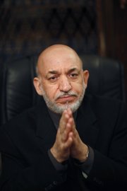 Afghanistan’s President Hamid Karzai speaks Thursday to The Associated Press at the Presidential Palace in Kabul. Karzai said he’s willing to talk with the Taliban chief in a bid to bring peace to the country if the move would have the backing of the United States and other international partners.