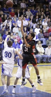 Lawrence High's Anthony Buffalomeat puts up a shot over Washburn Rural junior Austin Werner during the first half, Friday, Dec. 4, 2009 at Washburn Rural High School in Topeka.
