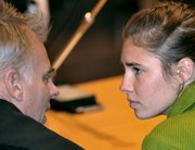 U.S. murder suspect Amanda Knox shares a word with her Italian lawyer Carlo Dalla Vedova, left, prior to a final hearing before the verdict Friday at the court in Perugia, Italy. Knox was found guilty of murdering her British roommate and sentenced to 26 years in prison.