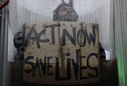 Mohamad Shinaz, a climate activist from Maldives, holds a sign reading “Act Now Save Lives” as he is submerged in water in a 9-foot tube Monday on the opening day of the climate conference in Copenhagen. The low-lying Maldives are at risk of flooding from rising sea levels.