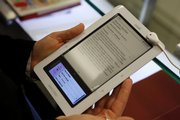 A customer tries out a Nook electronic book reader at Barnes and Nobles in New York. The Nook, Kindle and Sony Reader are in competition for the e-book market.