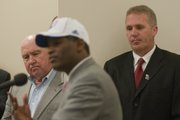 Chuck Long, right, and John Hadl, left, listen to Turner Gill’s introductory news conference on Dec. 14, 2009. Long, KU’s offensive coordinator, and Gill have a wealth of experience in dealing with quarterbacks. Hadl was a standout QB at both KU and in the NFL.