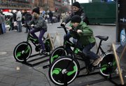 Danish people try out bicycles being set up to produce electricity Sunday in the center of Copenhagen, Denmark. It isn’t easy getting Italy’s city dwellers onto bicycles to ride to work, “like here in Copenhagen,’’ said an Italian environmental official during the climate summit.
