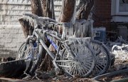 Bicycles coated in ice sit in the back of the home at 17th and Tennessee after it was destroyed in a fire Monday night.