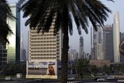 A billboard of Sheik Mohammed Bin Rashid Al Maktoum, UAE Prime Minister and ruler of Dubai, is seen in front of Sheikh Zayed highway towers in this July 30 file photo in Dubai, United Arab Emirates. Dubai got a $10 billion lifeline from neighboring emirate Abu Dhabi to save one of its prized companies from imminent default Monday.