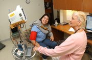 U.S. Army veteran Dee Myerly, Gerrardstown, W.Va., gets her blood pressure checked by Dolly Doherty, LPN, Nov. 13 at the Veterans Affairs Medical Center’s Treatment/Triage Room at the Well Woman’s Clinic in Martinsburg, W.Va. More VA hospitals and services are seeing female veterans applying for their services after the Iraq and Afghanistan wars.