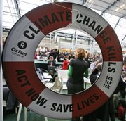 People gather Tuesday in one of the halls of the Bella Center in Copenhagen where the U.N. Climate Summit is under way. U.N. Secretary-General Ban Ki-moon says rich and poor countries must “stop pointing fingers” and raise their climate targets to salvage faltering talks on a global warming pact.