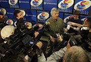 Newly-hired KU defensive coordinator Carl Torbush talks with media members during a news conference at Allen Fieldhouse shortly after his arrival into town, Friday, Dec. 18, 2009.