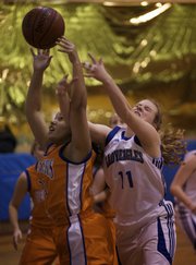 Veritas' Madison Bennett (11) battles for a rebound during the second half of the game against Wichita Defenders on Friday, Dec. 18, 2009, at the Eudora Community Learning Center.