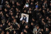 Mourners attend the funeral ceremony of Iran’s Grand Ayatollah Hossein Ali Montazeri, shown in the posters, the spiritual father of the nation’s reform movement, Monday in Qom, Iran.