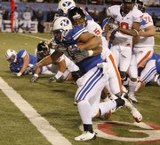 BYU running back Harvey Unga carries Oregon State safety Cameron Collins into the end zone for a touchdown in the Las Vegas Bowl. BYU won, 44-20, Tuesday in Las Vegas.