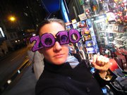 A woman tries on a pair of 2010 glasses on sale in New York City. Many people doubted that the popular New Year’s Eve eyewear would survive after the convenient double zeroes gave way to a number with “1” in the third position. But spectacle makers took on the challenge with varying — and mostly symmetrical — results.