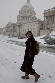 Sen. Lisa Murkowski, R-Alaska, leaves the Senate on Saturday in the snow following an early morning vote on Capitol Hill in Washington. Senators have been working odd hours lately, but the job has its perks.