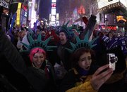 Revelers celebrate the New Year at the stroke of midnight Friday in New York’s Times Square. Leaders around the world expressed hope that the new year would be a time of renewal after a decade of war, recession, terrorism and threats of environmental catastrophe.