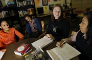 Jessica Moore, third from left, editor and publisher of Teen Voices Magazine, listens to peer leaders and teen editors, from left, Agostinha DePina, 17, Reynelle Dickson, 16, and Sally Nguyen, 18, Tuesday in Boston. Moore, 34, had been steadily employed since graduating from college more than 10 years ago. But last March, she found herself unemployed for the first time after her job was cut as Web site designer in New York.