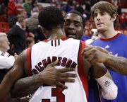 Kansas guard Sherron Collins hugs Nebraska guard Brandon Richardson following the Jayhawks' 84-72 win over the Huskers, Wednesday, Jan. 13, 2010 at the Devaney Center in Lincoln, Nebraska.
