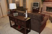 Using the same table adds some new display and storage furniture to a spot behind a couch that was empty and not being utilized.