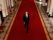 President Barack Obama walks down the Cross Hall of the White House in Washington, to hold his first news conference, Feb. 9, 2009, in the East Room. Obama enters his second year in office leading a country struggling to find its footing.