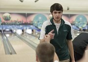Adam Miltner celebrates with teammates during a Free State bowling quad meet at Royal Crest Lanes Thursday, Jan. 28, 2010. Miltner had just completed a game rolling a 242, which he followed with a second game 186.