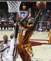 Texas guard Damion James, right, shoots in front of Oklahoma forward Ryan Wright during their game Saturday in Norman, Okla. James leads the Longhorns into today’s Big Monday game against Kansas.