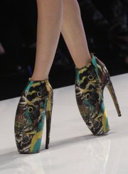 A model presents Lobster claw shoes, a creation by British fashion designer Alexander McQueen, in this Oct. 6, 2009, file photo. McQueen was found dead at his London home on Thursday, his spokeswoman said. He was 40 years old.