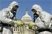 Members of the U.S. Marine Corps’ Chemical-Biological Incident Response Force demonstrate anthrax cleanup techniques during a news conference Oct. 30, 2001, on Capitol Hill in Washington.