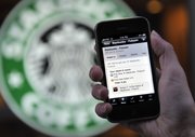 In this Nov. 20, 2009, file photo, the Foursquare application is shown on an iPhone in front of a Starbucks in San Francisco.