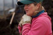 Stephanie Thomas, of Spring Creek Farm, takes a break from planting onions at her farm. She grows about 80 varieties of produce on three acres.