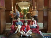 The Skirvin Hilton hotel in Oklahoma City is allegedly haunted, but KU graduates Todd and Andrea Jones and their son Carter, 9, Overland Park, are feeling lucky to be following the Jayhawks. The Jones family is pictured Friday, March 19, 2010 in the lobby of the Skirvin.