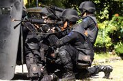 Indonesian anti-terror police squad members take part in a drill ahead of President Barack Obama’s visit, which has been delayed, Saturday in Kuta, Bali, Indonesia.
