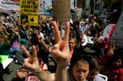 Stephanie Lee and Ben Kuebrich take part in a protest for the Iraq war on Hollywood Boulevard on Saturday in Hollywood, Calif. The protest was on the seventh anniversary of the U.S. invasion of the Iraq War. The ANSWER coalition staged the anti-war protest.