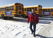 Marc Horner, fleet manager for Jefferson County public schools in Lakewood, Colo., walks near school buses with advertisements on their sides at the school’s bus maintenance facility. Several states allow advertising on school buses, including Colorado, Arizona, Florida, Minnesota, Tennessee and Texas.