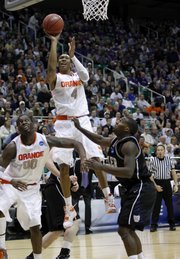 Syracuse's Wes Johnson (4) goes up for a shot as Butler's Shelvin Mack, right, and Syracuse's Rick Jackson, left, look on in the second half of an NCAA West Regional semifinal college basketball game in Salt Lake City, Thursday, March 25, 2010.