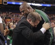 Michigan State coach Tom Izzo, left, is congratulated by former Michigan State player Earvin “Magic” Johnson after the Spartans defeated Tennessee on Sunday in St. Louis to advance to the Final Four.