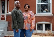 Will and Roxanne Ward, pictured in this March 13 photo in St. Louis, have entered a national competition to conserve household energy. The Ward family in the city’s Oak Hill neighborhood will strive to cut energy consumption for three months. The Wards’ home was built in 1911.