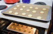 Using a recipe from 1610, Keri Behre, Lawrence, bakes up some "sweet cakes." The recipe called for, among other things, nutmeg, mace and rosewater.