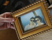 Steve Haddock displays a photograph of his parents, Ken and Barbara Haddock, while they’re on a hot-air balloon ride. Ken is serving a life sentence at Lansing Correctional Facility for Barbara’s 1992 murder, but his children, Steve, Jen and Jody believe he is innocent and are trying to prove it in court.