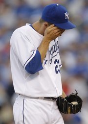 Kansas City Royals starting pitcher Zack Greinke wipes his face after giving up back-to-back home runs to the Boston Red Sox during the fifth inning. The Royals lost, 8-3, on Saturday in Kansas City, Mo.