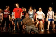 LHS senior Evan Georgie tears through an air guitar solo during a rehearsal for “Showtime,” which opens Thursday at the school, 19th and Louisiana streets.