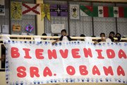 Students at Siete de Enero primary school stand behind a banner welcoming first lady Michelle Obama on Wednesday to their school in a low-income neighborhood of Mexico City. The sign reads in Spanish “Welcome Mrs. Obama.”