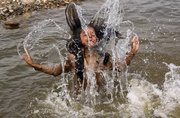A nomadic Gujjar girl plays in the River Tawi to get respite from the heat Friday in Jammu, India. Last month was the warmest March on record worldwide, based on records back to 1880, scientists reported Thursday.