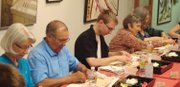 From left, Winona Ralston, Ruben Lopez, Erik Buchholz, Lynda Berendsen and Linda Baranski learning to make sushi at a sushi-making class April 10 at 1109 Gallery in downtown Lawrence. The class was held in tandem with the “Art is Zen” exhibit by the Lawrence Art Guild, which runs through April 30 at the gallery.