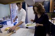 National Geographic chef Barton Seaver, left, offers sauteed lionfish to Renata Lana, a communications and outreach specialist from NOAA, Tuesday in the kitchen of Seaver’s home in Washington, D.C.